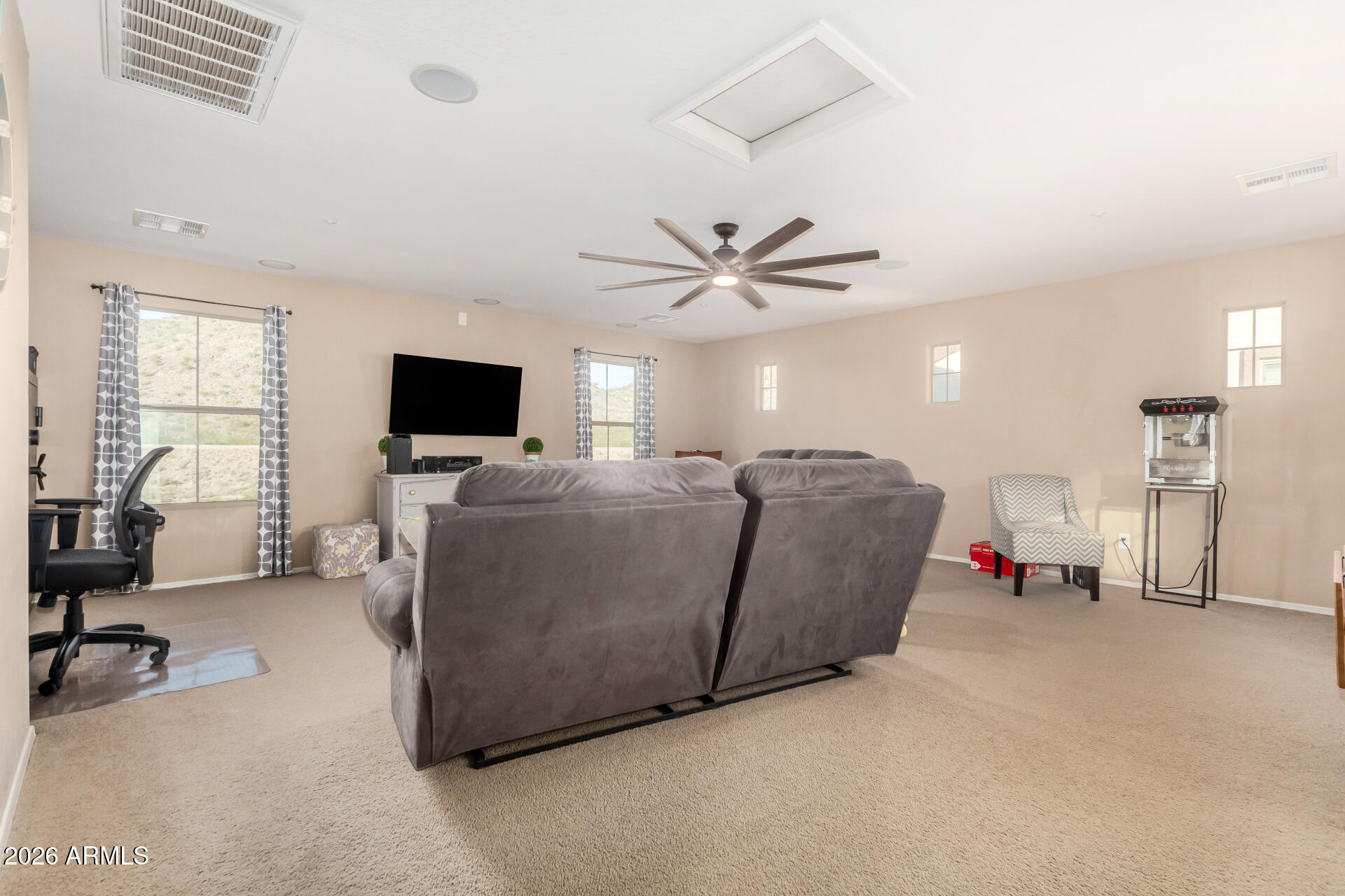 7316 West Montgomery Road Peoria, AZ 85383 - Photo 21 of 49 a living room with furniture and a flat screen tv