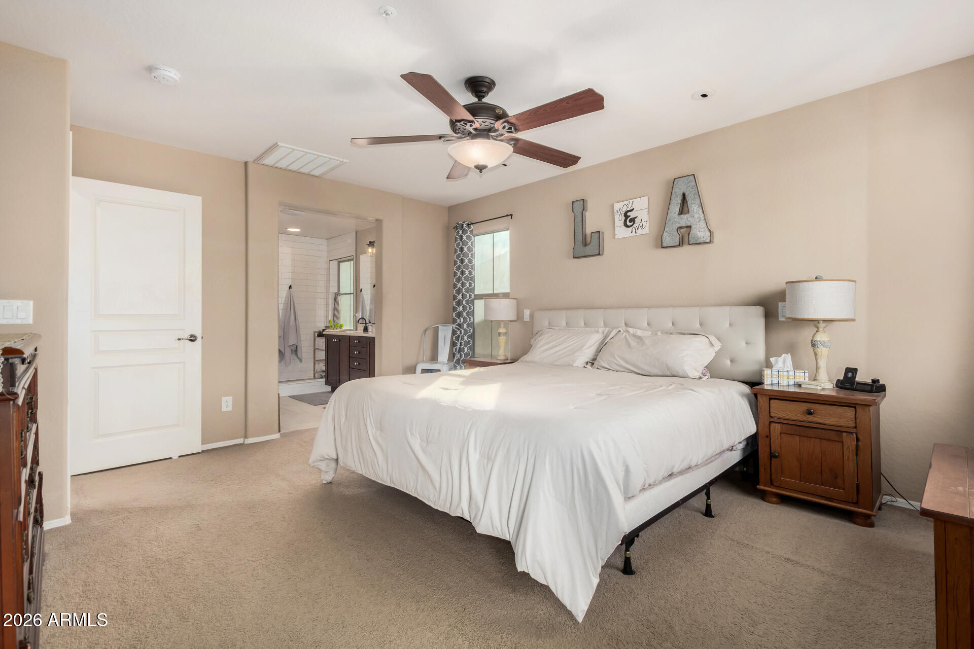 7316 West Montgomery Road Peoria, AZ 85383 - Photo 25 of 49 a bedroom with a large bed and ceiling fan