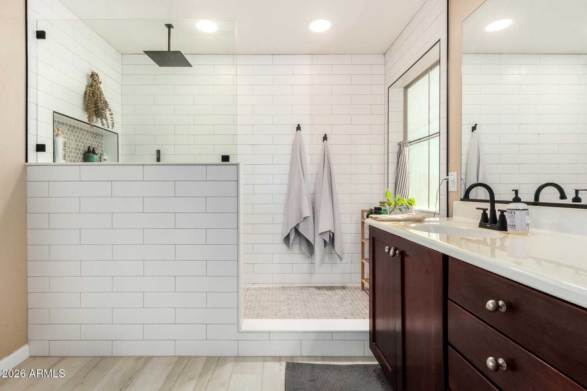 7316 West Montgomery Road Peoria, AZ 85383 - Photo 28 of 49 a bathroom with a double vanity sink a mirror and shower