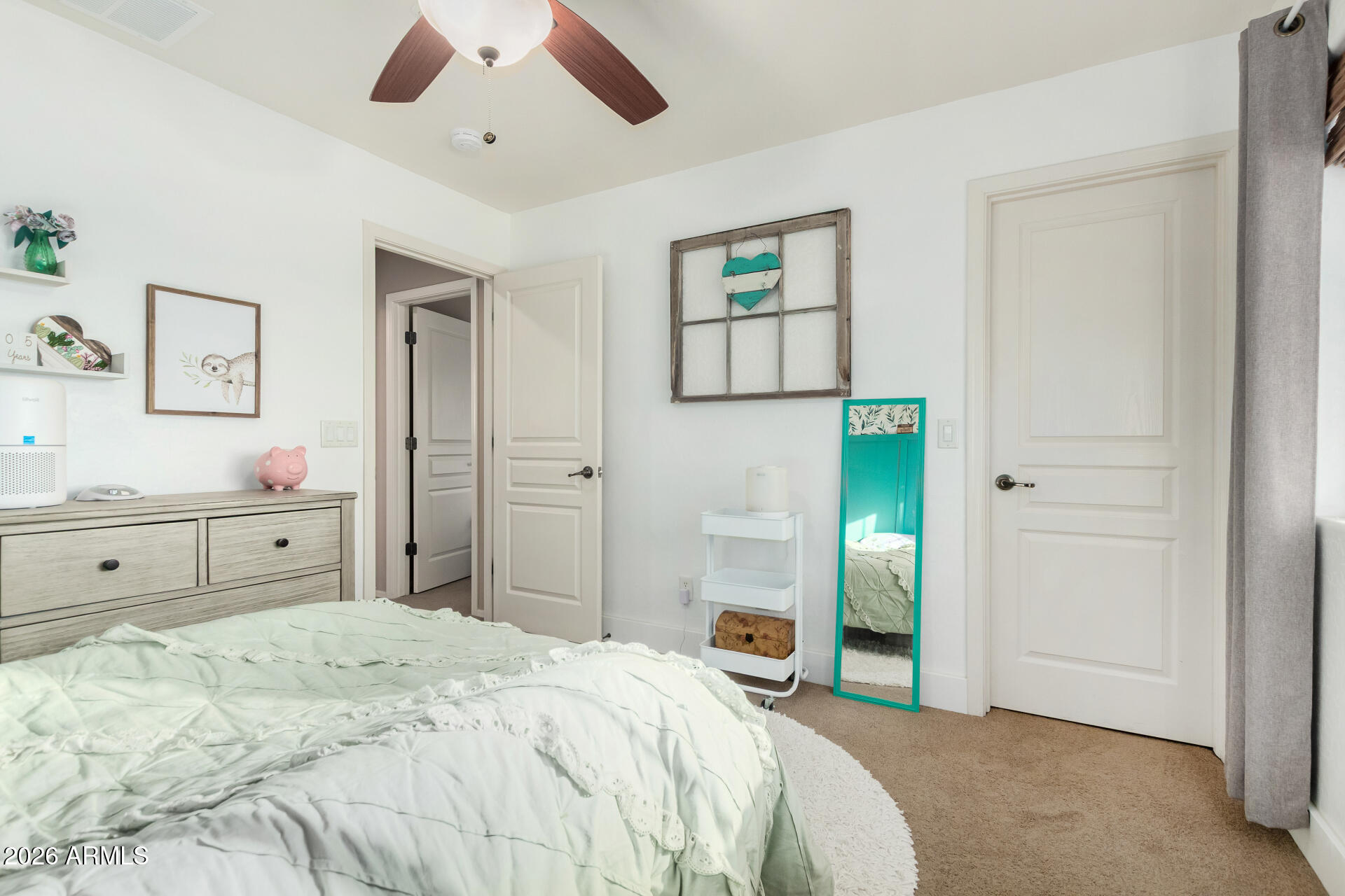 7316 West Montgomery Road Peoria, AZ 85383 - Photo 31 of 49 a bedroom with a bed and a chandelier