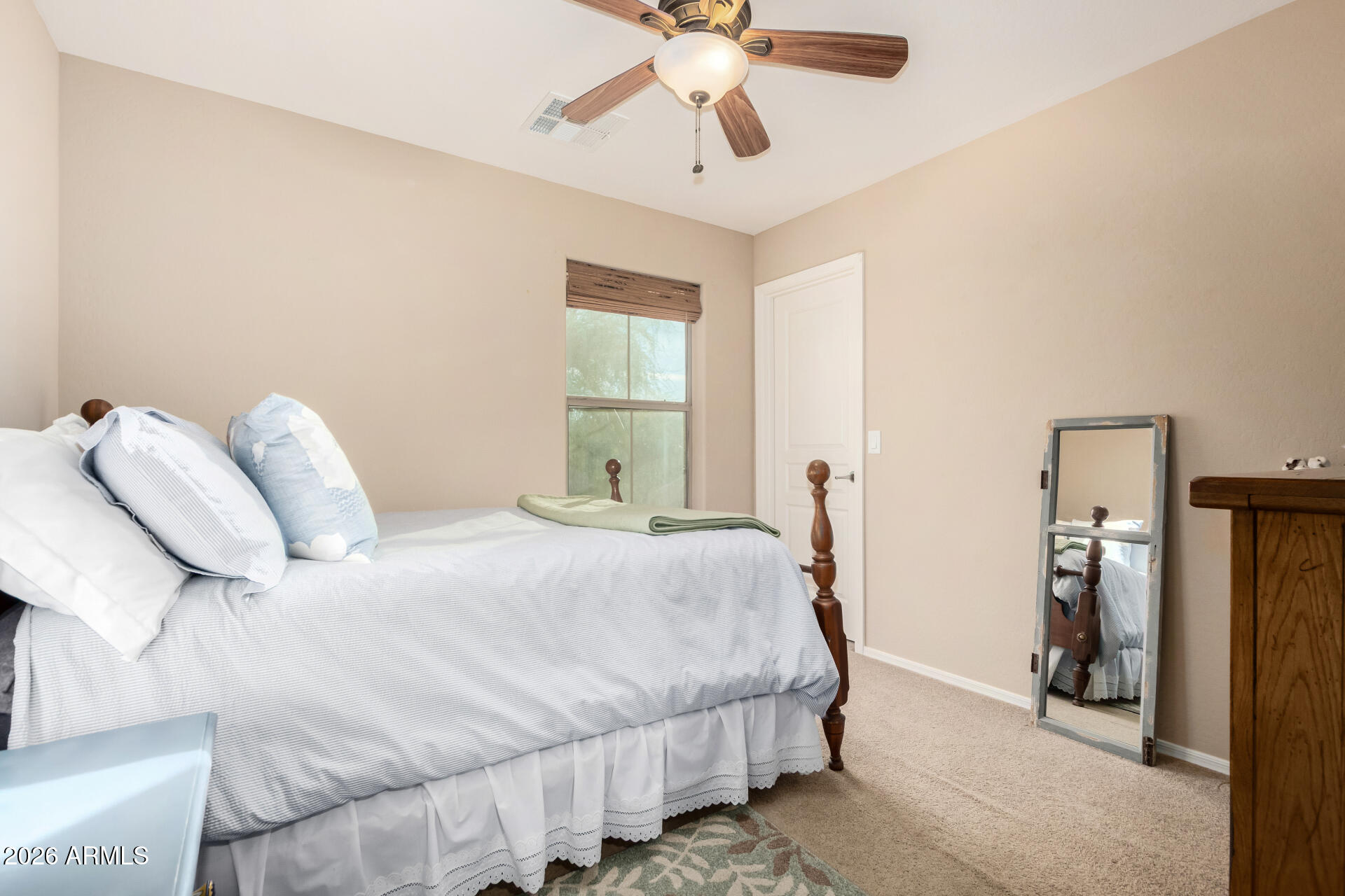 7316 West Montgomery Road Peoria, AZ 85383 - Photo 32 of 49 a bedroom with a bed and a chandelier