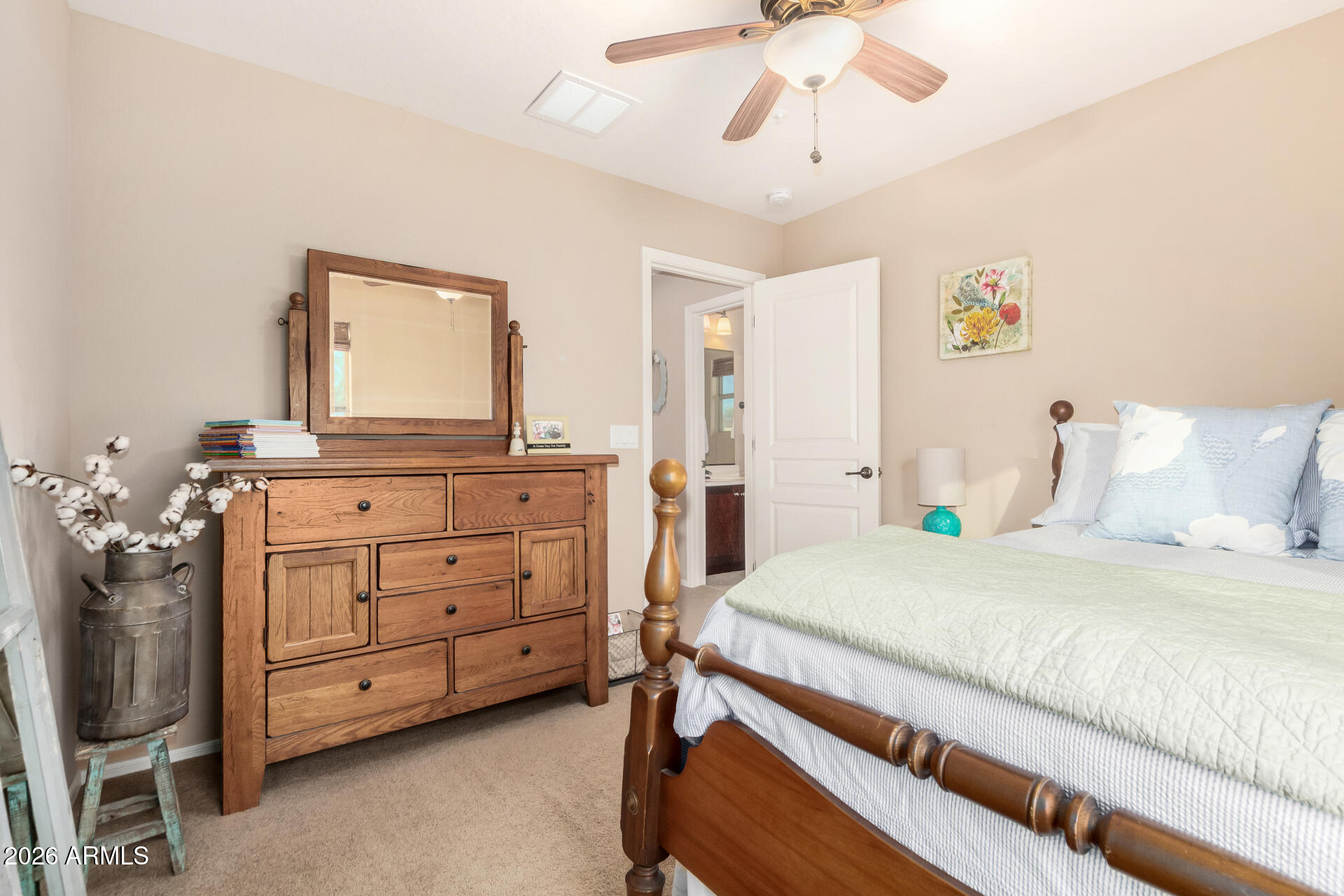 7316 West Montgomery Road Peoria, AZ 85383 - Photo 33 of 49 a bedroom with a bed a chandelier and a dresser