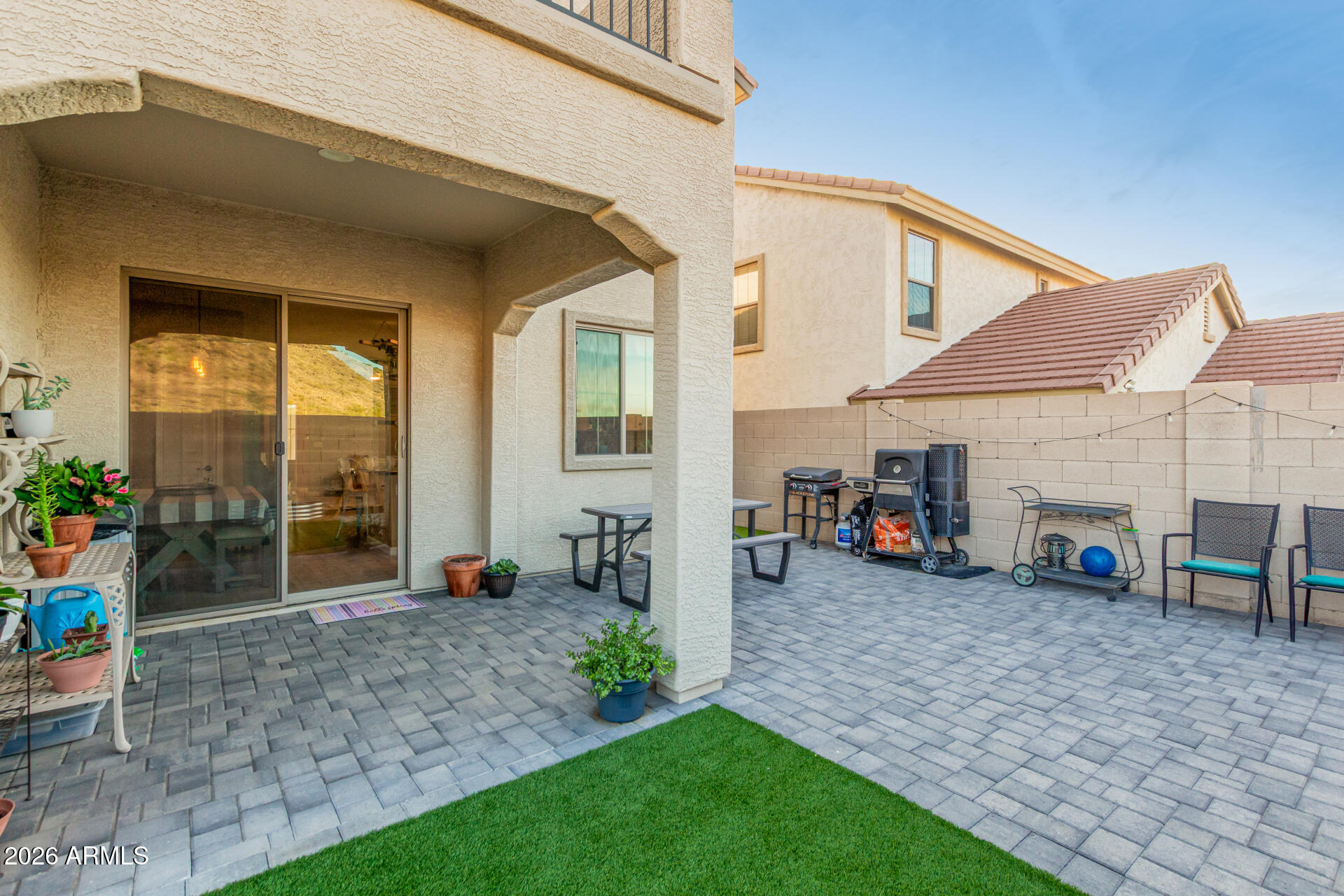 7316 West Montgomery Road Peoria, AZ 85383 - Photo 39 of 49 a view of a house with a patio and a yard