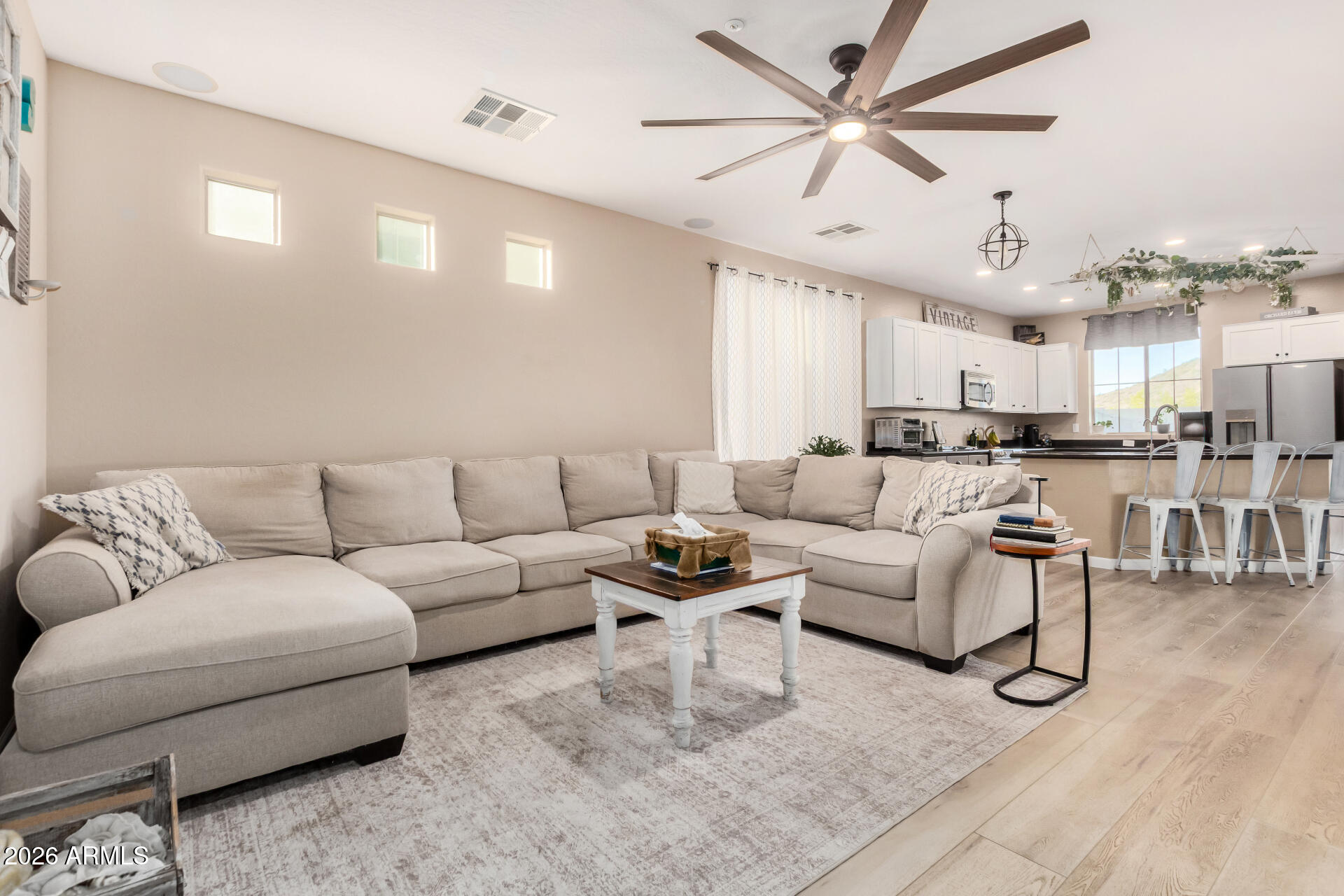 7316 West Montgomery Road Peoria, AZ 85383 - Photo 5 of 49 a living room with furniture kitchen view and a chandelier
