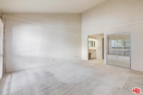 a view of an empty room with glass door