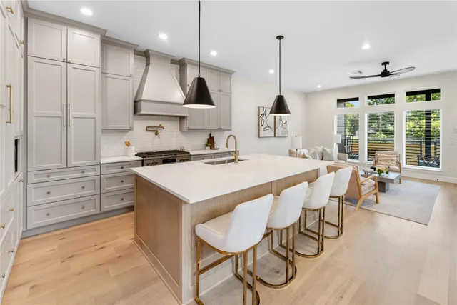 a kitchen with a table chairs stove and wooden floor