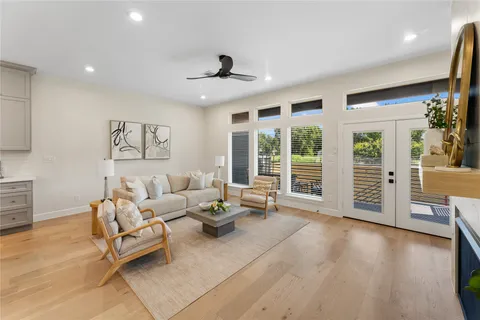 a living room with furniture and wooden floor
