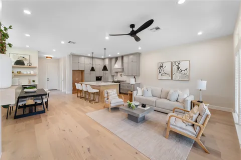 a living room with furniture and kitchen view