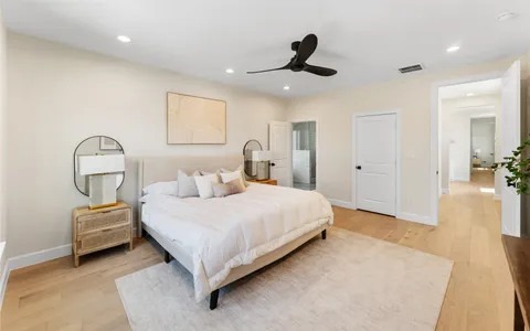 a bathroom with a granite countertop sink a toilet and shower