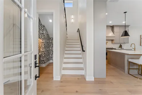 a view of entryway with furniture and wooden floor