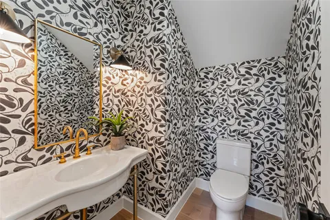 a bathroom with a toilet and a shower curtain