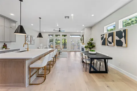 a open kitchen with stainless steel appliances kitchen island a large island in the center