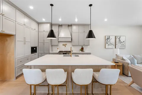 a large kitchen with furniture and a chandelier