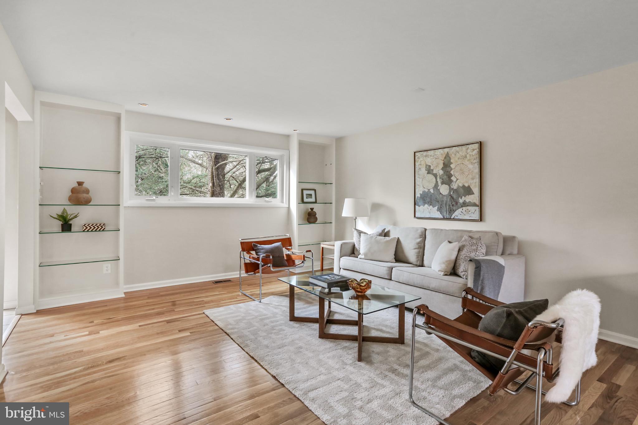7207 Denberg Road Baltimore, MD 21209 - Photo 10 of 62 Living room with built-in shelving with glass.