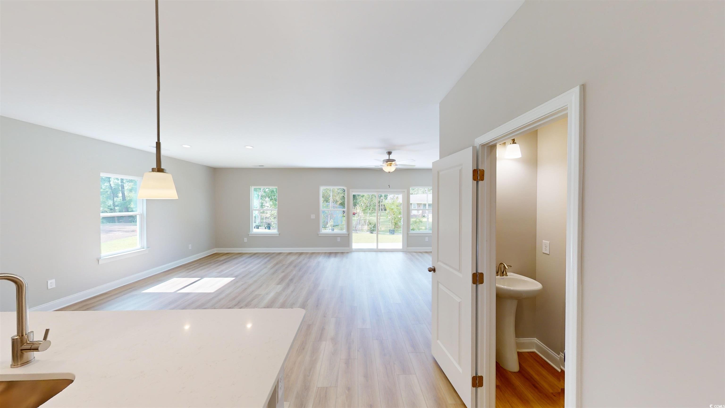 1016 Moen Loop, Unit LOT 5 Conway, SC 29526 - Photo 15 of 31 Unfurnished living room featuring light wood-style flooring and ceiling fan