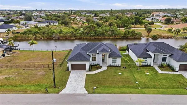 a large kitchen with stainless steel appliances kitchen island a large counter top a stove and a sink