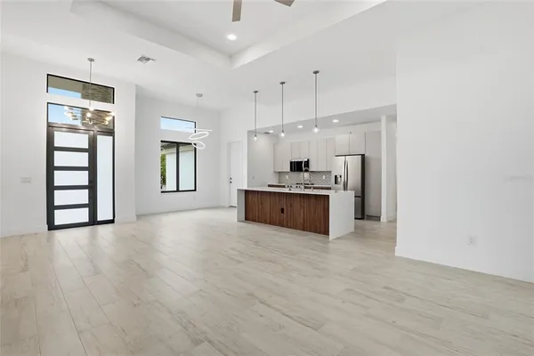 a large kitchen with kitchen island a sink stainless steel appliances and cabinets
