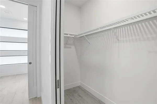 an empty room with windows and closet