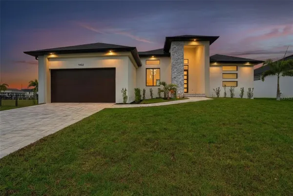 a view of an house with backyard and porch