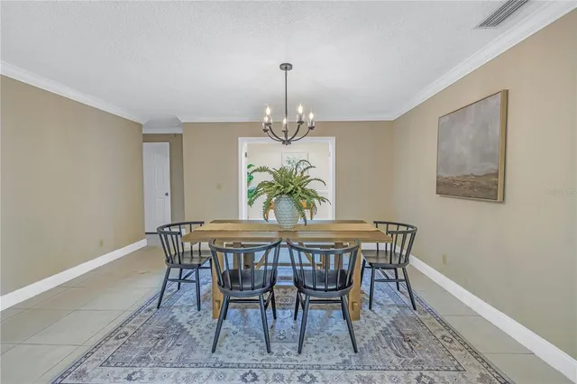 a dining room with furniture and chandelier