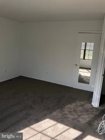 a view of a closet area with wooden floor