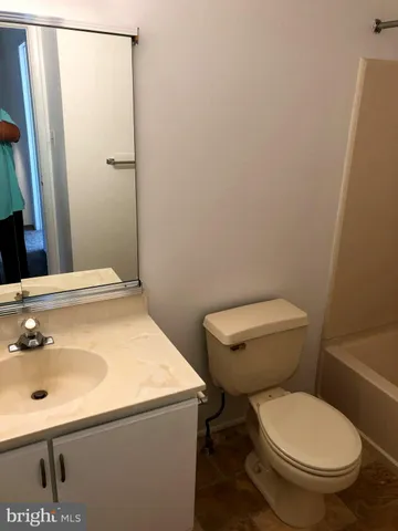 a white toilet sitting next to a bathroom sink