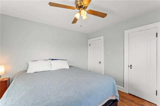 a room with a bed and a ceiling fan