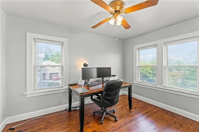 a workspace with wooden floor and a window