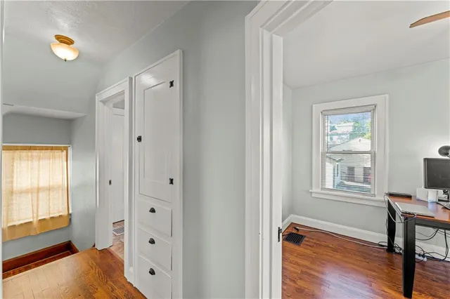 a view of room with window and wooden floor