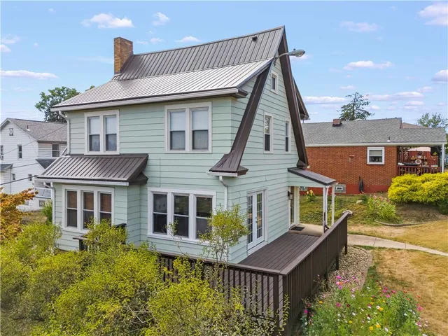 a view of a house with wooden deck