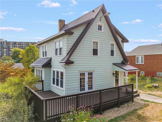 a view of a house with wooden fence