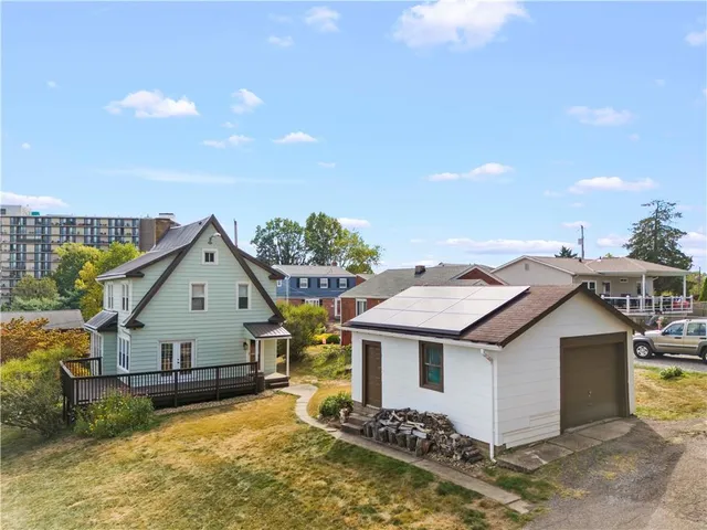 an aerial view of a house with a yard basket ball court and outdoor seating