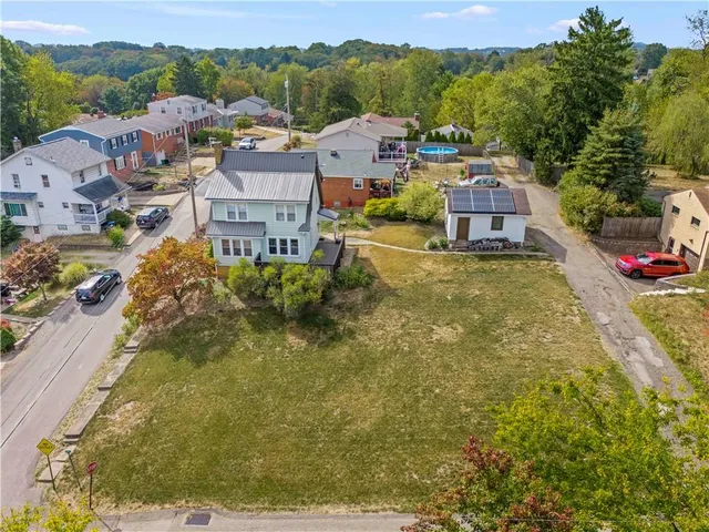 an aerial view of a houses with a swimming pool