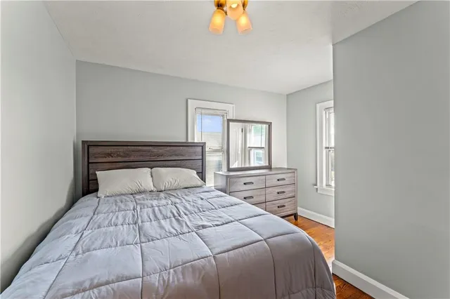 a bedroom with a large bed and a chandelier