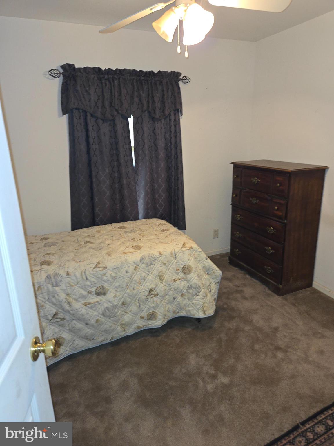 30921 Johnson Road Salisbury, MD 21804 - Photo 11 of 11 a bedroom with a bed and a dresser