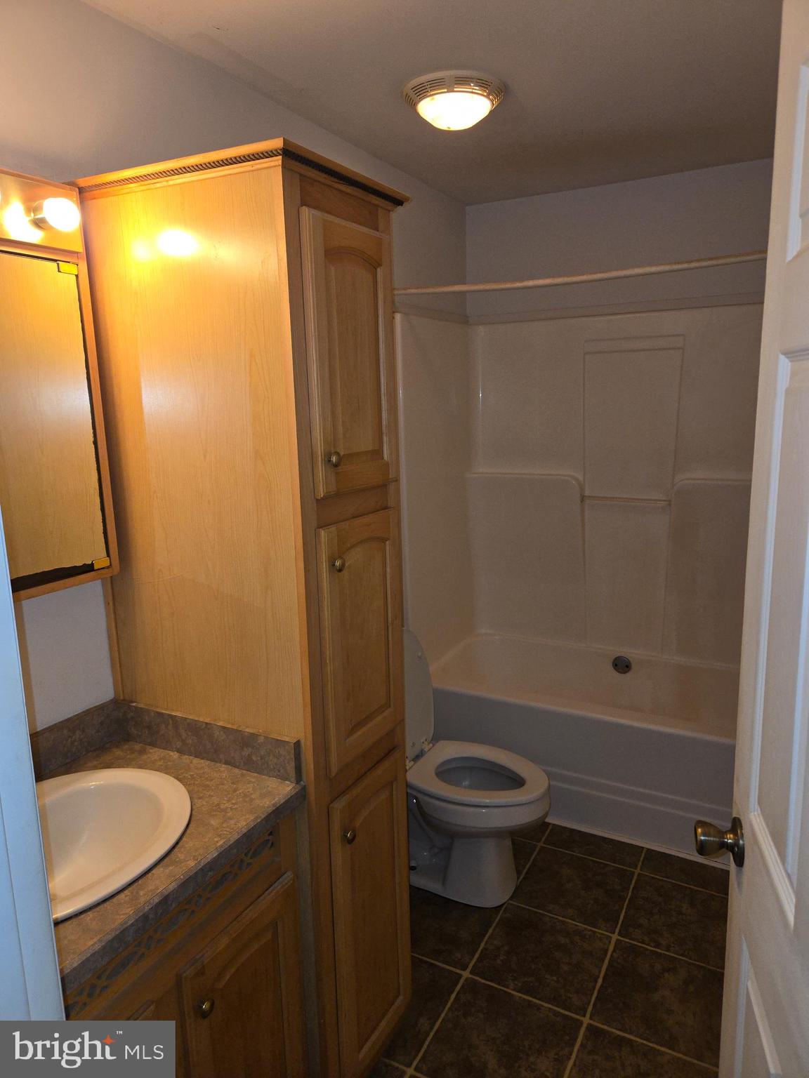 30921 Johnson Road Salisbury, MD 21804 - Photo 8 of 11 a bathroom with a granite countertop sink toilet and shower