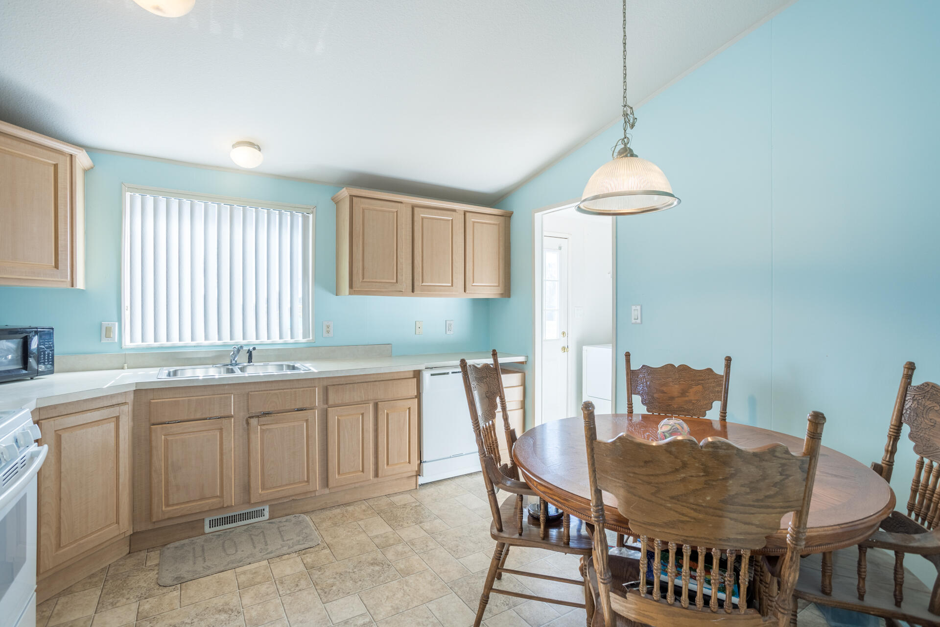 11541 Homestead Lane Redding, CA 96003 - Photo 29 of 51 a kitchen with a table chairs and a sink