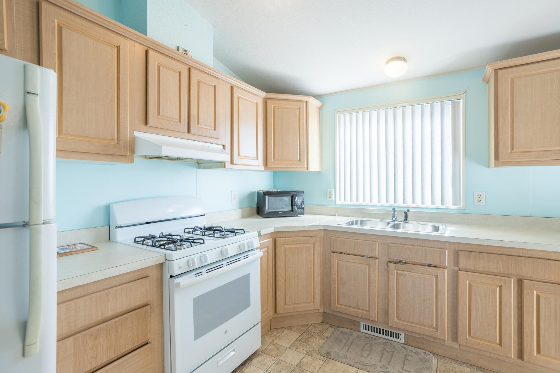 11541 Homestead Lane Redding, CA 96003 - Photo 30 of 51 a kitchen with white cabinets and white appliances