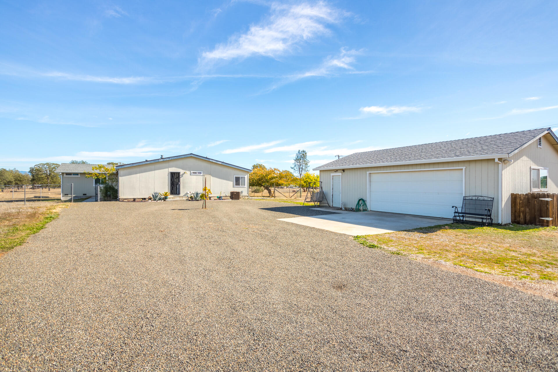 11541 Homestead Lane Redding, CA 96003 - Photo 7 of 51 a yellow house with trees in front of it