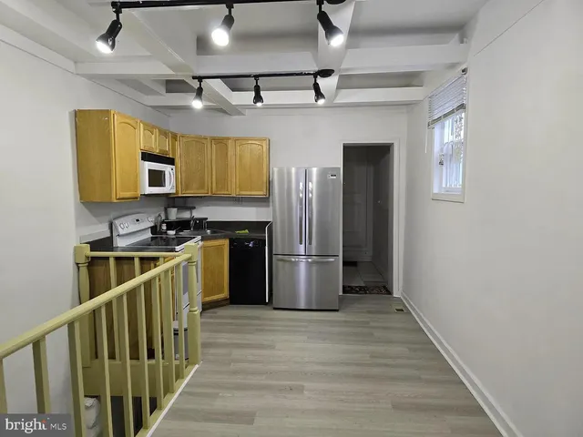 a kitchen with stainless steel appliances granite countertop a refrigerator a stove a sink dishwasher and a refrigerator