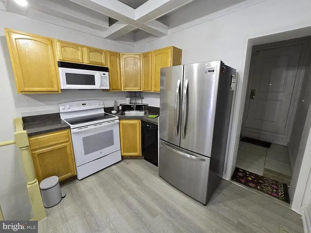 a view of a kitchen with a sink and cabinets