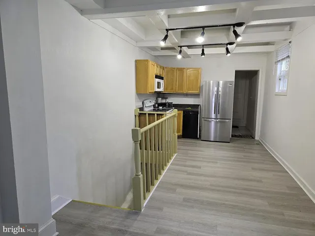 a view of hallway with wooden floor and furniture