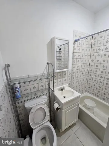a bathroom with a sink a bathtub and shower