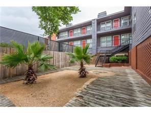 2804 Rio Grande Street, Unit 307 Austin, TX 78705 - Photo 14 of 14 View of property's community featuring a fenced backyard and stairs