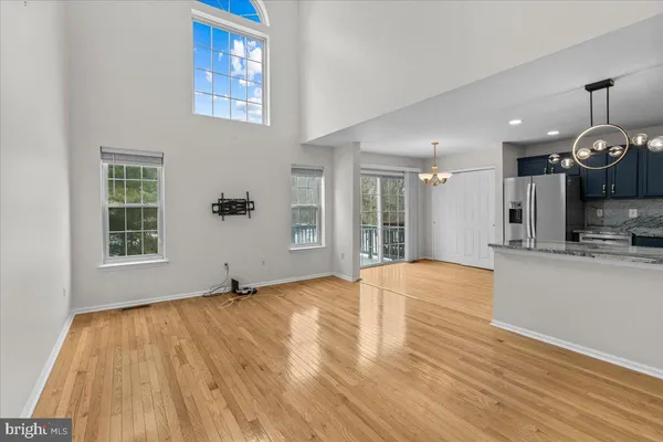 a kitchen with stainless steel appliances granite countertop a sink stove a refrigerator and a wooden cabinets