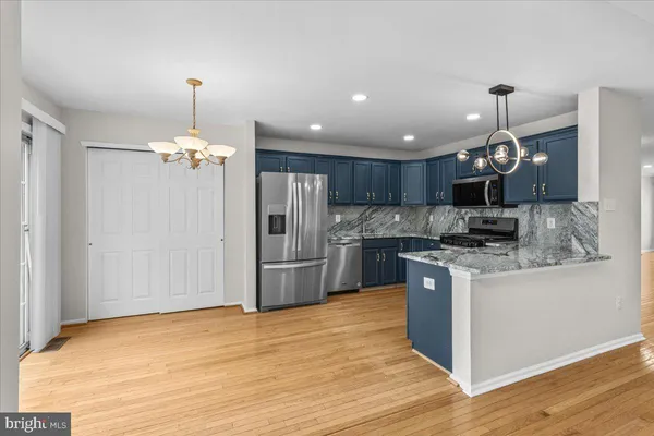 a view of a room with wooden floor and ceiling fan