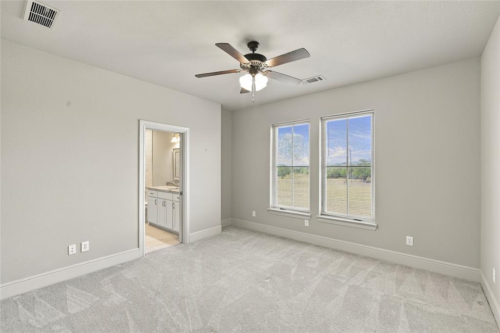 1180 Wiggins Road Maypearl, TX 76064 - Photo 30 of 40 Plush carpet and two large windows make this bedroom a cozy retreat for guests or family.