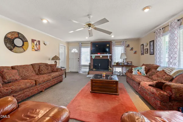 a living room with furniture and a fireplace