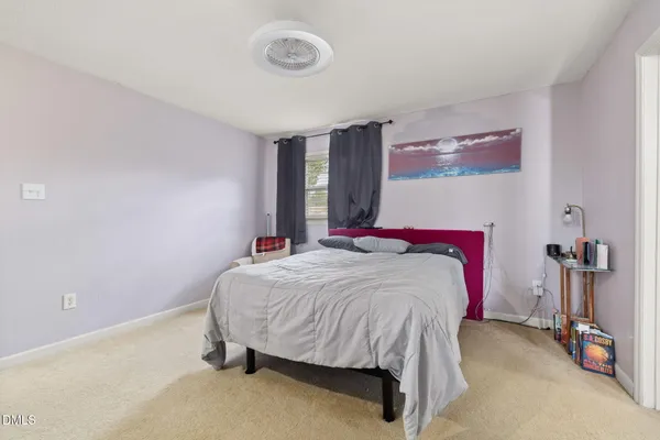 a bed sitting in a bedroom next to a window