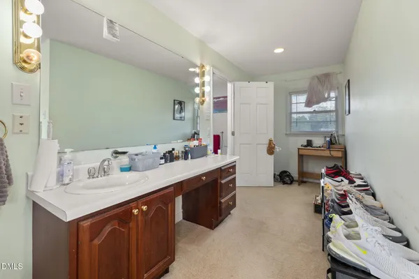 a kitchen with granite countertop a sink stove and cabinets